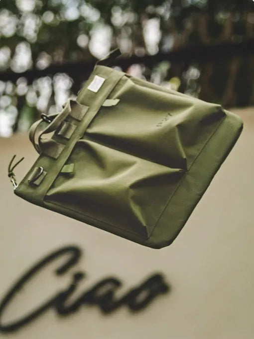 Marden Tooling military green canvas messenger bag with crossbody strap on a table
