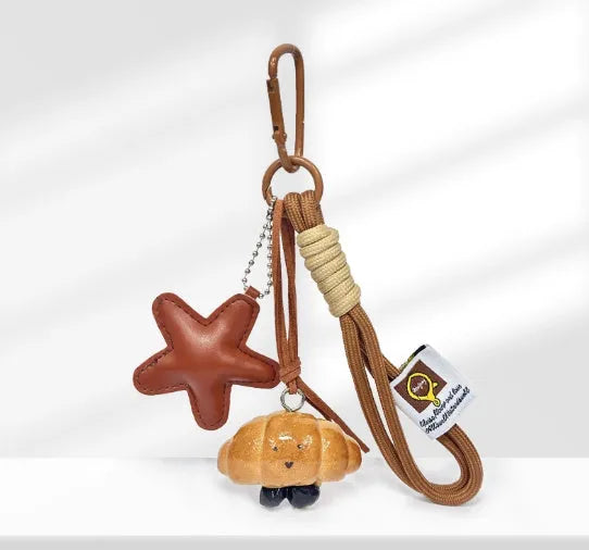 Handmade soda bread style handbag pendant charm with cartoon design and brown strap