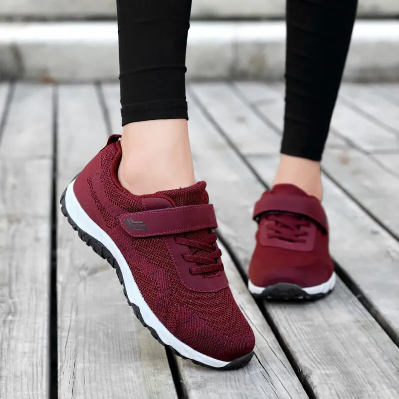 Women's low-top wedge heel shoes with mesh upper and Velcro strap in a solid colour.