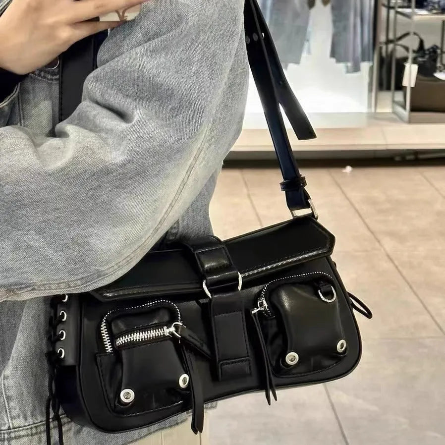 Black PU leather underarm baguette bag with adjustable shoulder strap shown in crossbody position