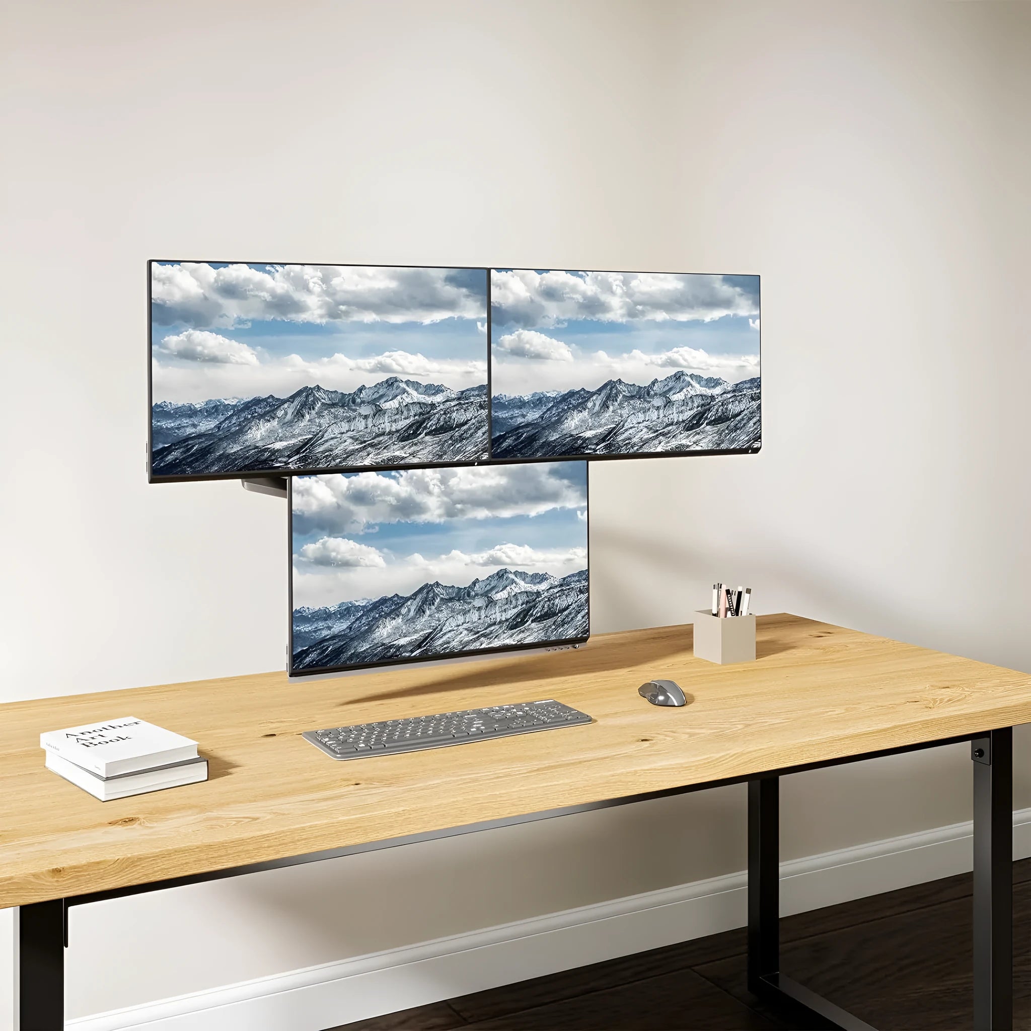 Black aluminium gas spring monitor arm holding a 27-inch computer screen