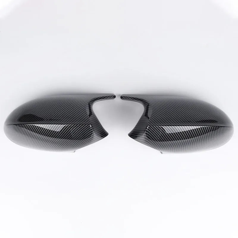 Pair of black ABS plastic rearview mirror shells for BMW 3 Series E90, shown alongside original equipment part numbers.