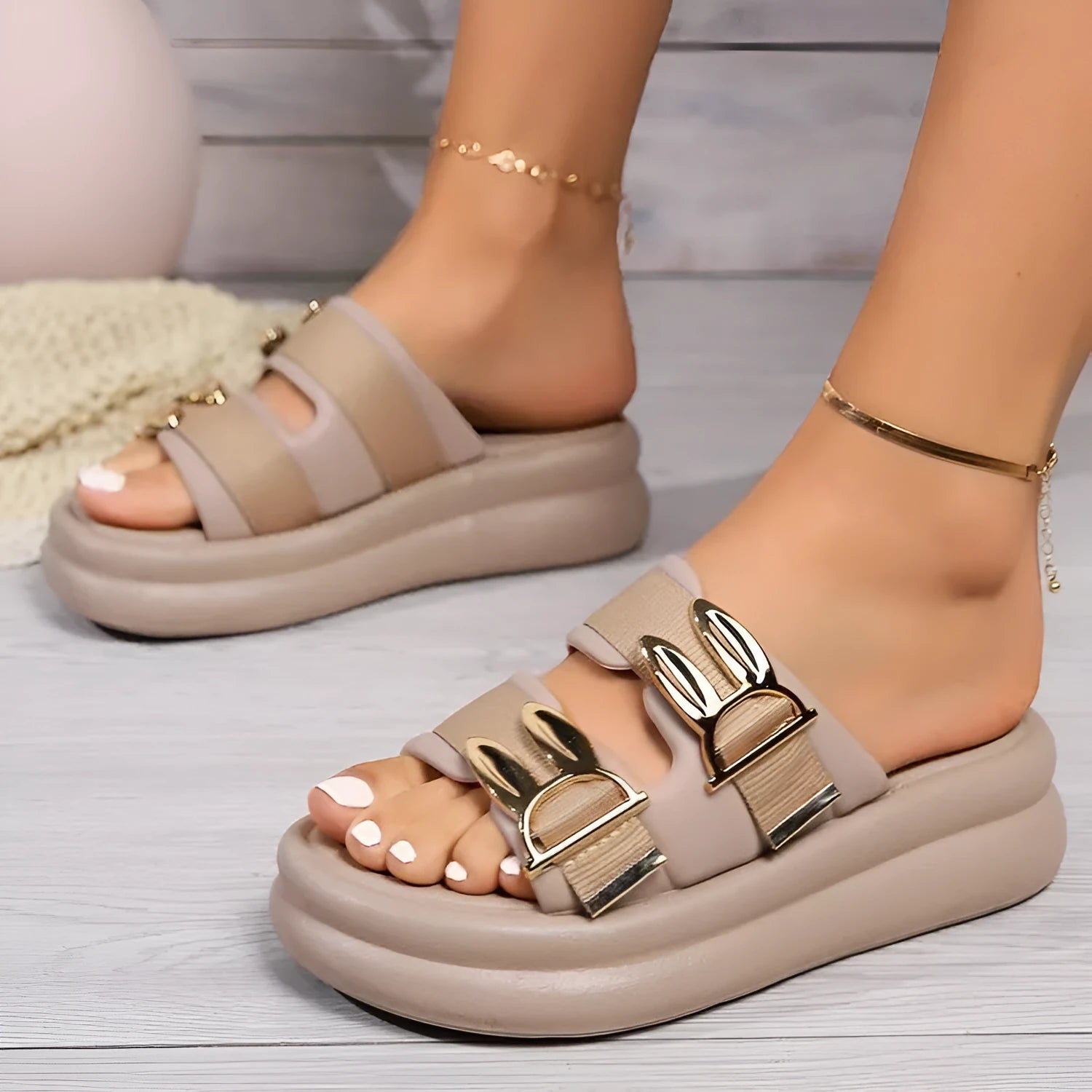Women's apricot suede slippers with thick rubber sole on wooden floor