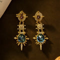A pair of gold colour geometric round stud earrings with a retro court style design.