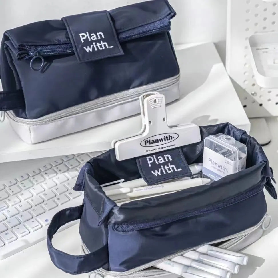 Dark blue double layer folding fabric pencil case open to show A4 layout with elastic pen slots.