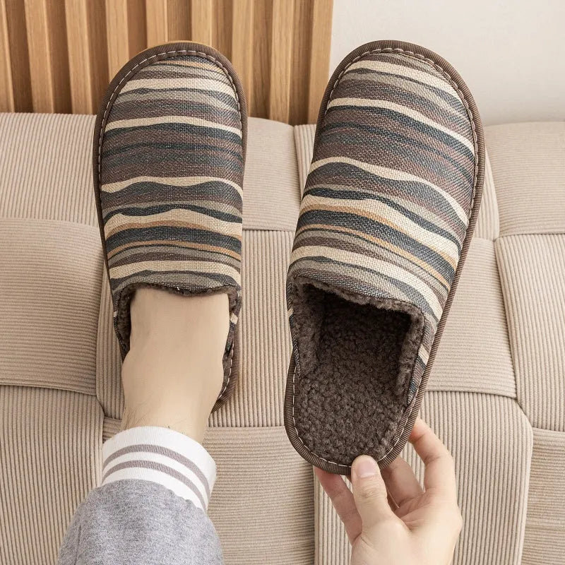 A pair of linen surface cotton lined slippers with a PVC sole, shown in a floral print colour option.