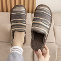A pair of linen surface cotton lined slippers with a PVC sole, shown in a floral print colour option.