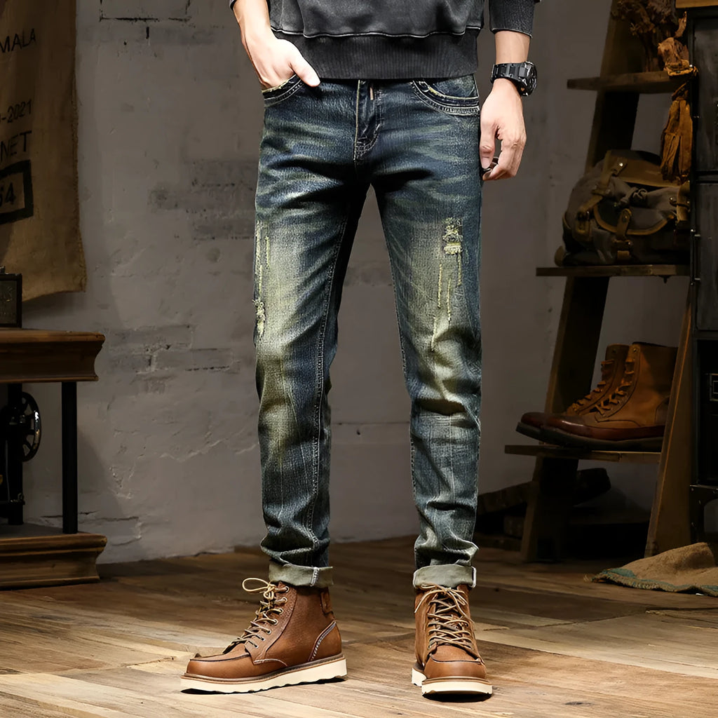 Men's skinny fit retro blue jeans with a zip fly on a grey background