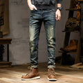 Men's skinny fit retro blue jeans with a zip fly on a grey background
