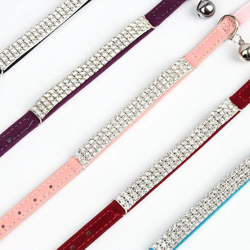 A velvet cat collar with a rhinestone decoration, shown in one of five colours, with an adjustable buckle.