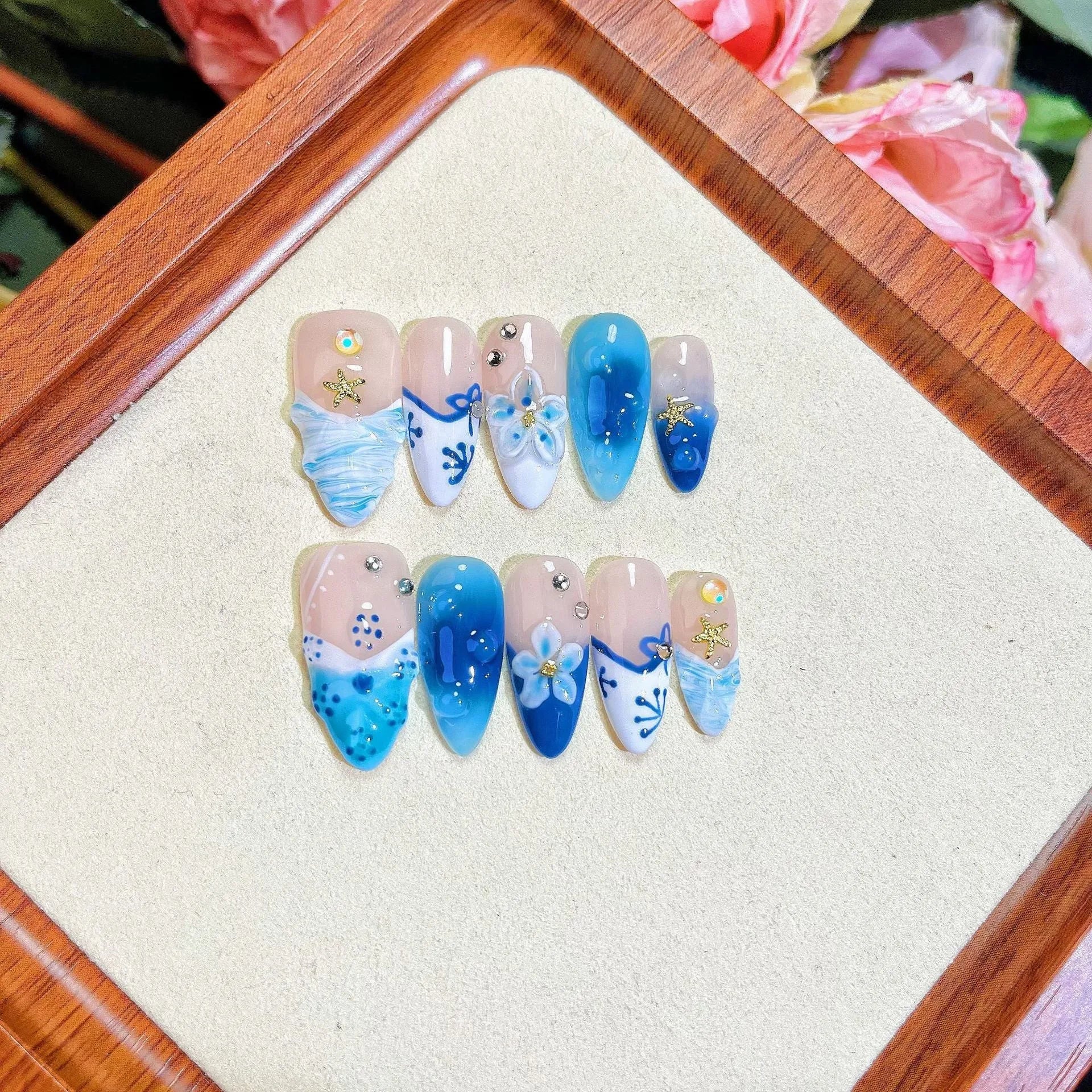 Blue hand-painted fake nails with carved transparent summer ice finish in four sizes