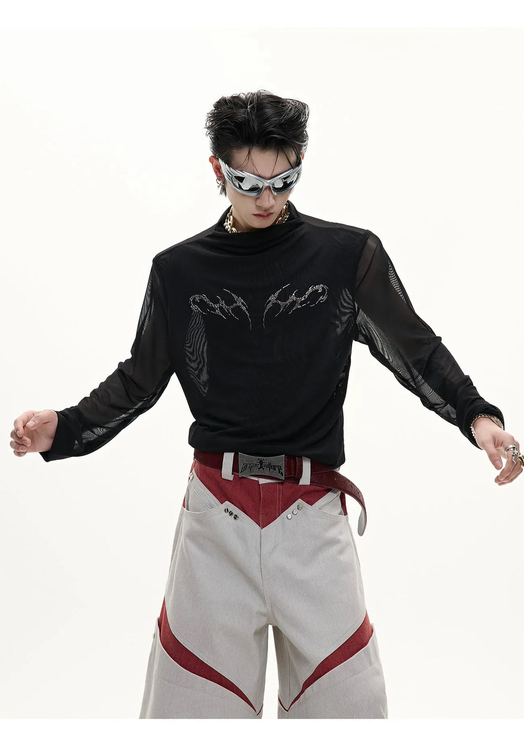 Man wearing a black slim fit long sleeve mesh base layer shirt.