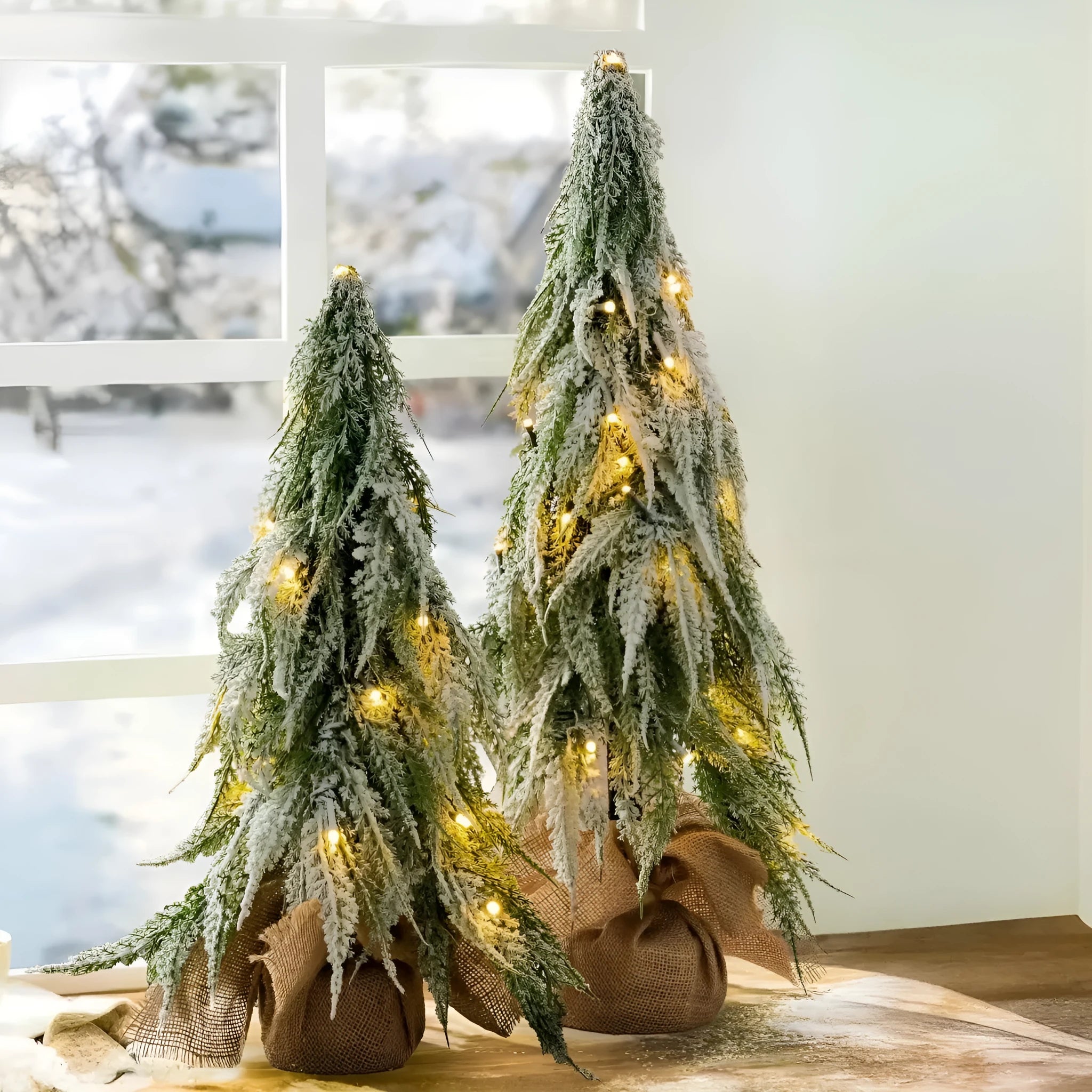 24 inch plastic Christmas tree with lights and PE snow decoration on desktop