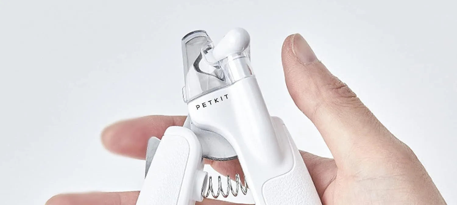 White pet nail clippers with LED light, transparent splash guard, and anti-slip handle.