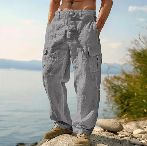 Man wearing light army green loose cotton wide-leg casual trousers with a mid waist.