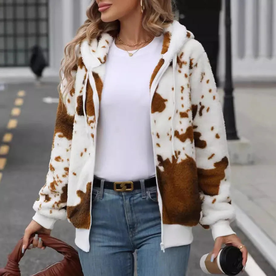 Yellow and brown cow print hooded cardigan jacket with a full front zip on a model.