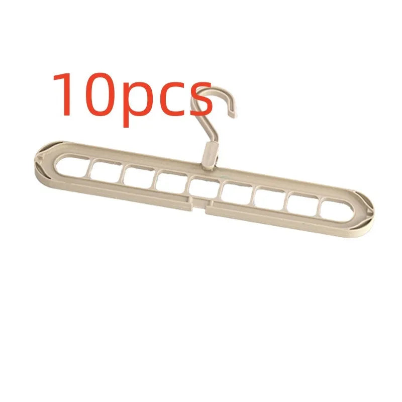 Green plastic nine-hole folding hanger for trousers shown in a dormitory wardrobe.