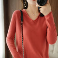 Women's V-neck long sleeve knitwear pullover top in a macaron colour on a hanger.