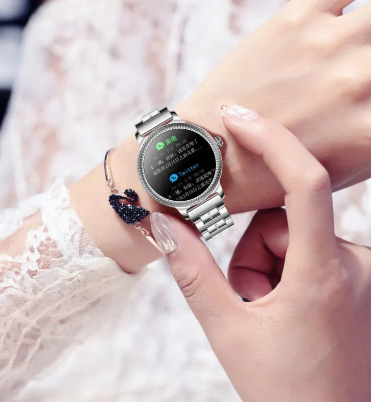 AK38 ladies smart watch with stainless steel Milanese strap and gold finish on wrist.