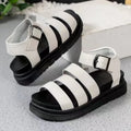 A pair of thick-soled casual sandals with an adjustable buckle strap over a black PU upper and rubber sole.