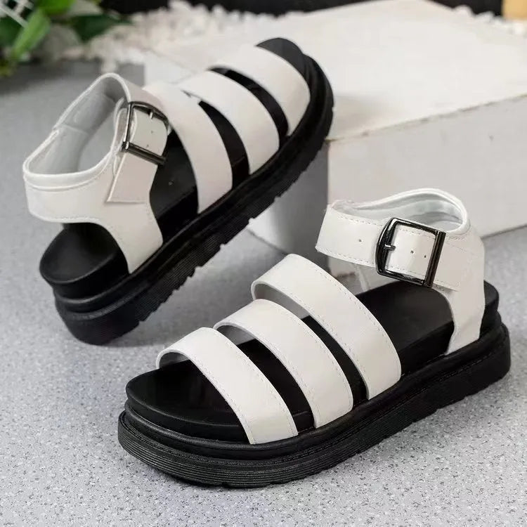 A pair of thick-soled casual sandals with an adjustable buckle strap over a black PU upper and rubber sole.