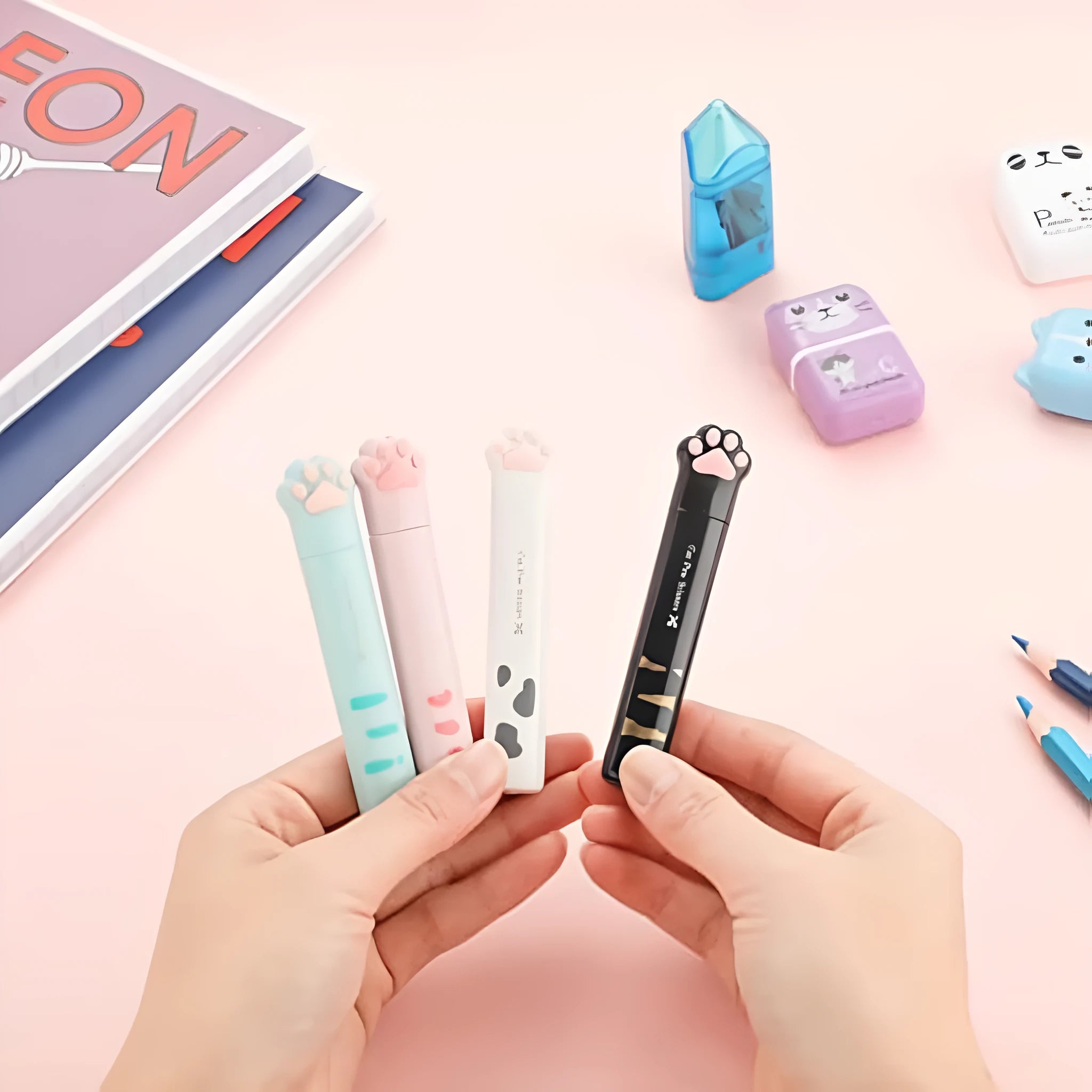 Closed pink cat paw mini folding safety scissors showing the cartoon handle design.