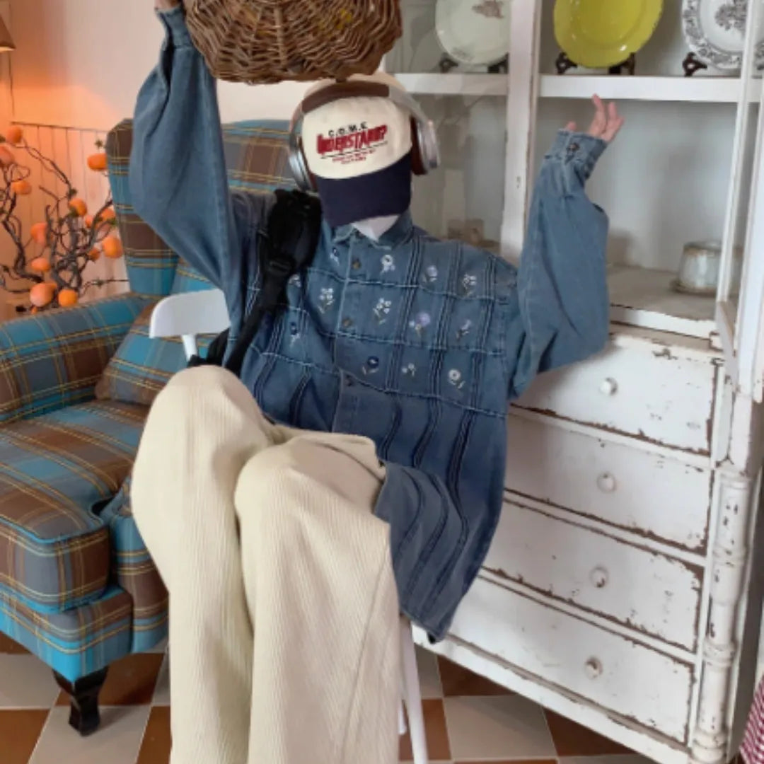 Vintage washed blue denim shirt with small floral print and pleated detailing on long sleeves