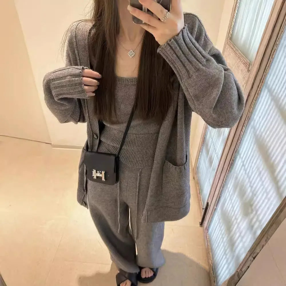 Women's knit three-piece set showing cardigan coat, vest, and suspender trousers in beige colour