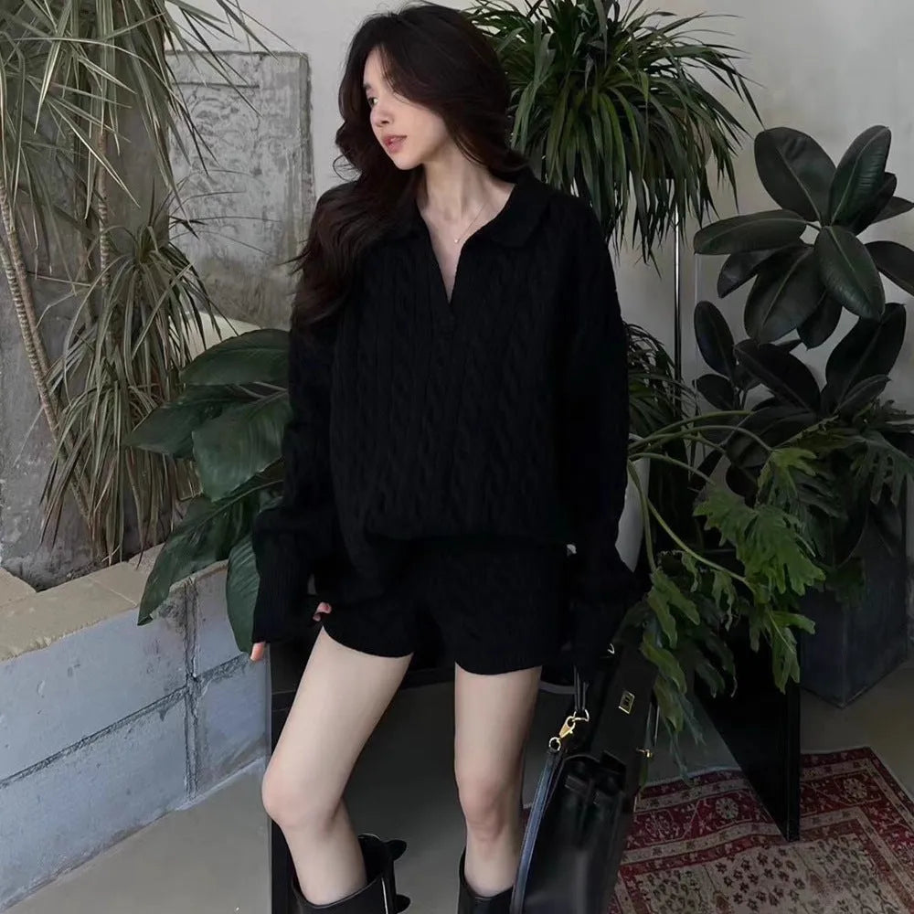 Women's knitted suit set showing cable knit geometric pattern on long sleeve sweater and matching elastic waist shorts