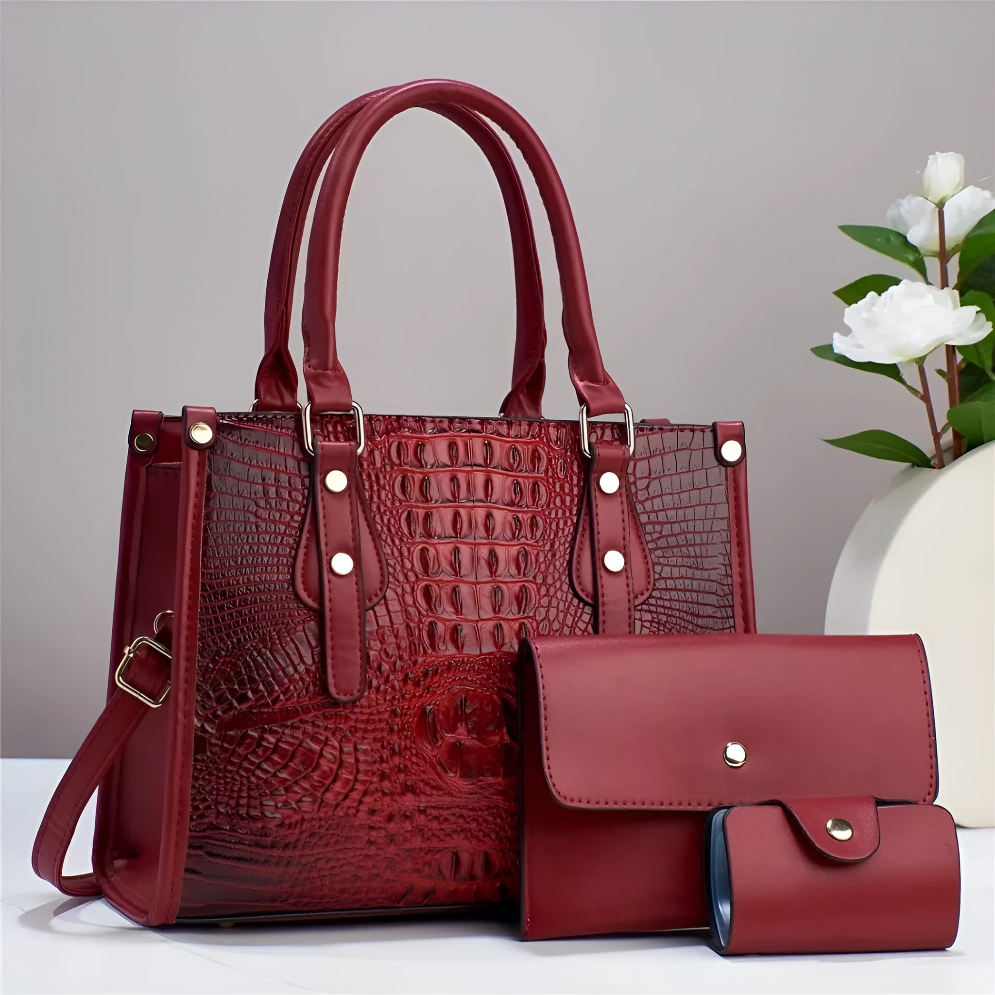 Minimalist textured PU three-piece bag set showing crossbody bag, wallet, and card holder in a contrast colour.