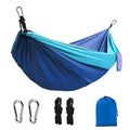 Blue parachute cloth nylon camping hammock shown hung between trees with 270cm length