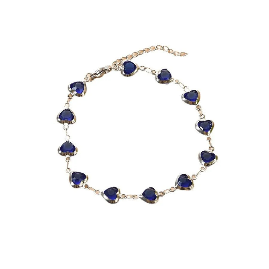 Devil's Eye geometric heart bracelet in stainless steel, shown in colourful, blue, green, and red finishes.