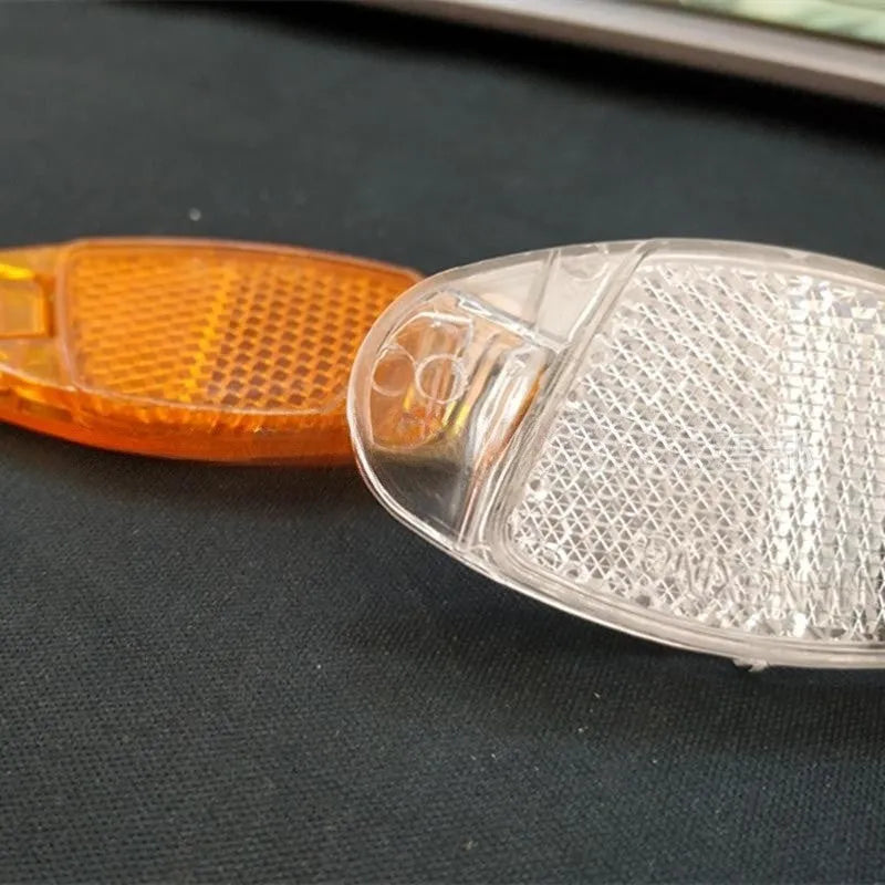 White and yellow plastic bicycle spoke reflectors with hot wheels decoration for night safety