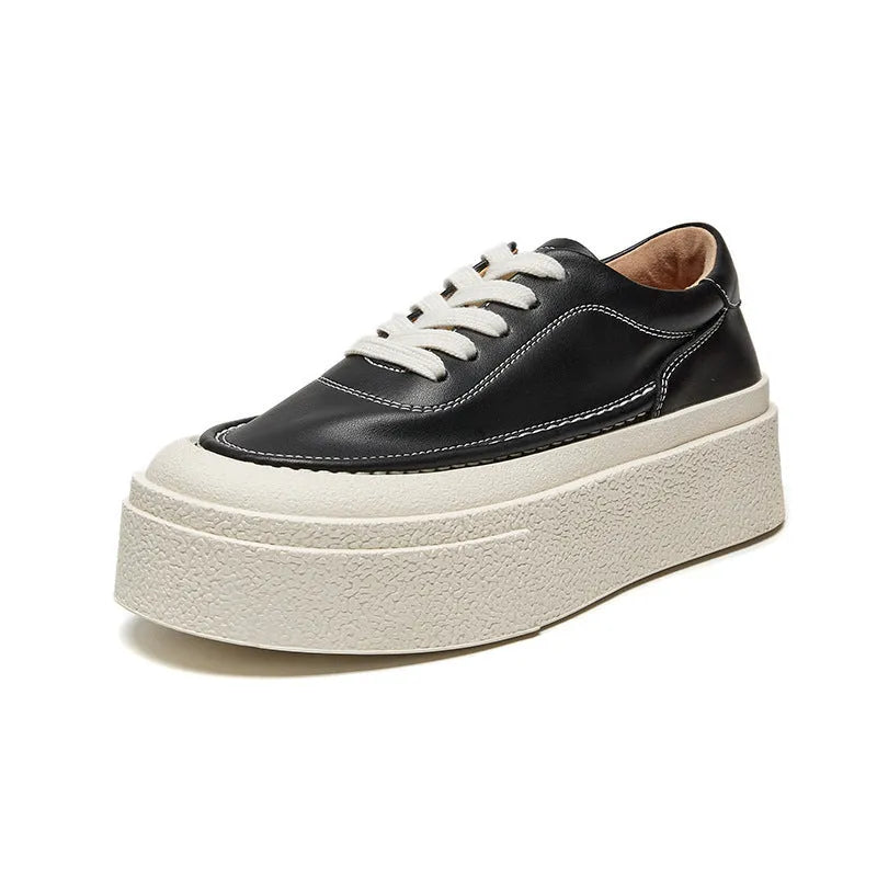 Women's black platform casual sports shoes with embossed leather upper and round toe.