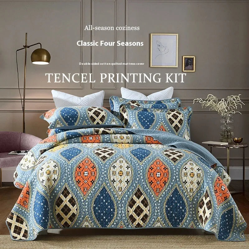 Quilted pure cotton bed cover set with printed pattern on a bed, includes two matching pillowcases.