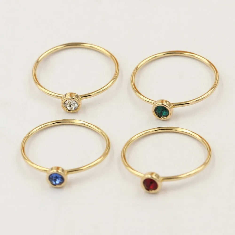 14K gold-plated GF zircon knuckle ring on finger in green colour