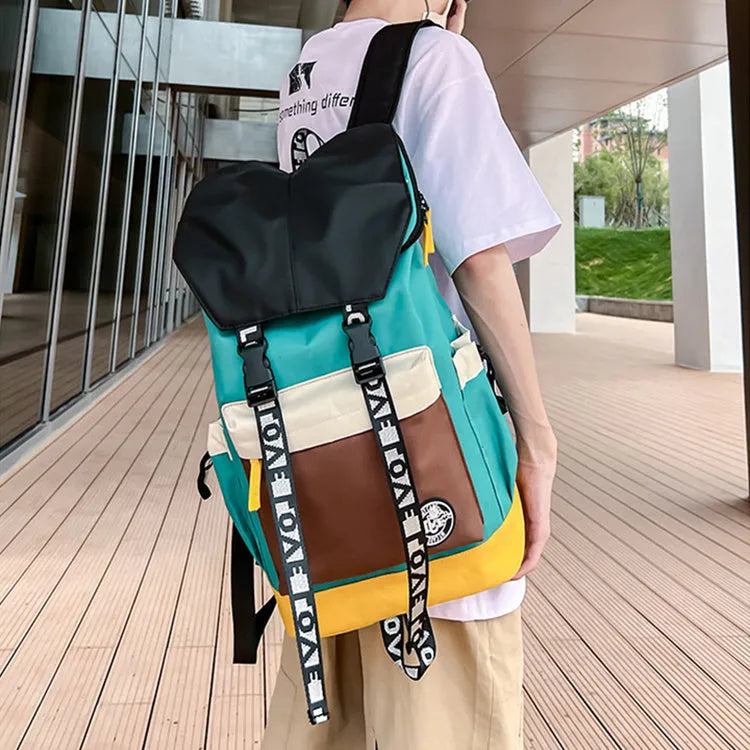 Oxford cloth backpack in black, green, or red with handheld grip and shoulder straps.