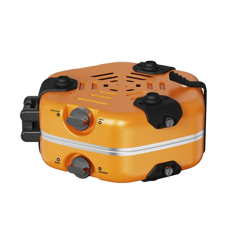 Orange portable double-headed butane camping gas stove folded and open on grass