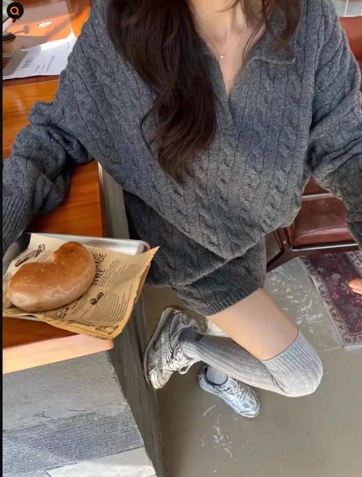 Women's knitted suit set showing cable knit geometric pattern on long sleeve sweater and matching elastic waist shorts