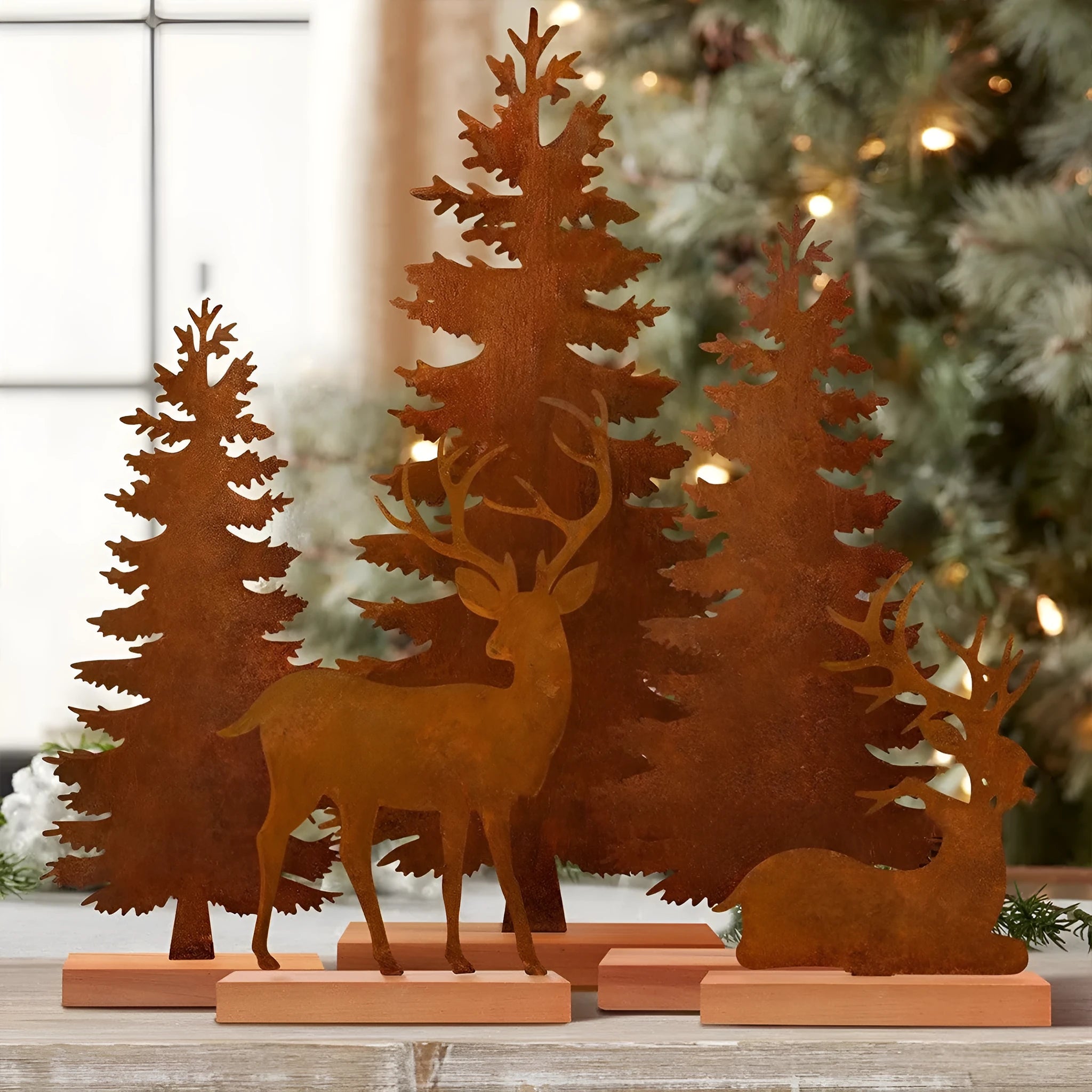 Three rustic metal Christmas tree ornaments with elk motifs in aged metallic finish