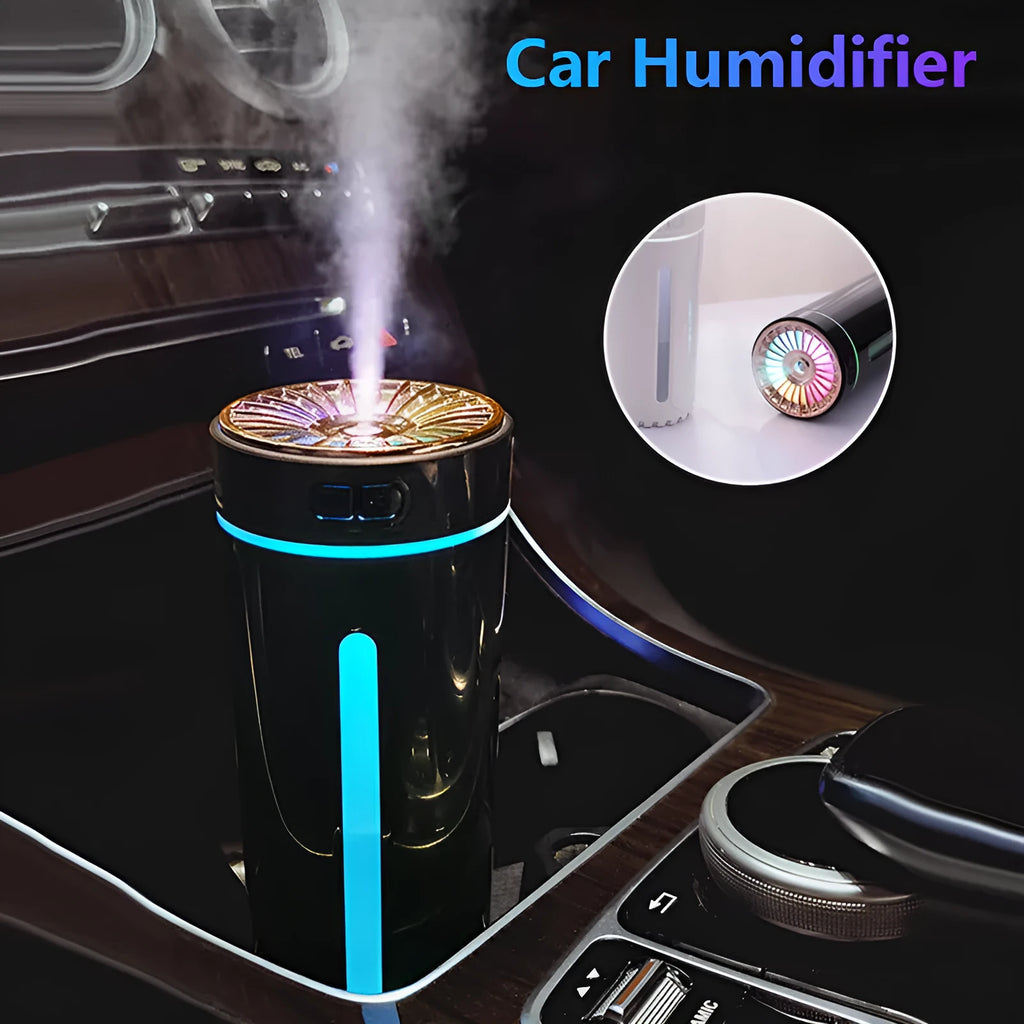 Black portable ultrasonic humidifier with colourful LED lights, shown next to a USB cable on a desktop.