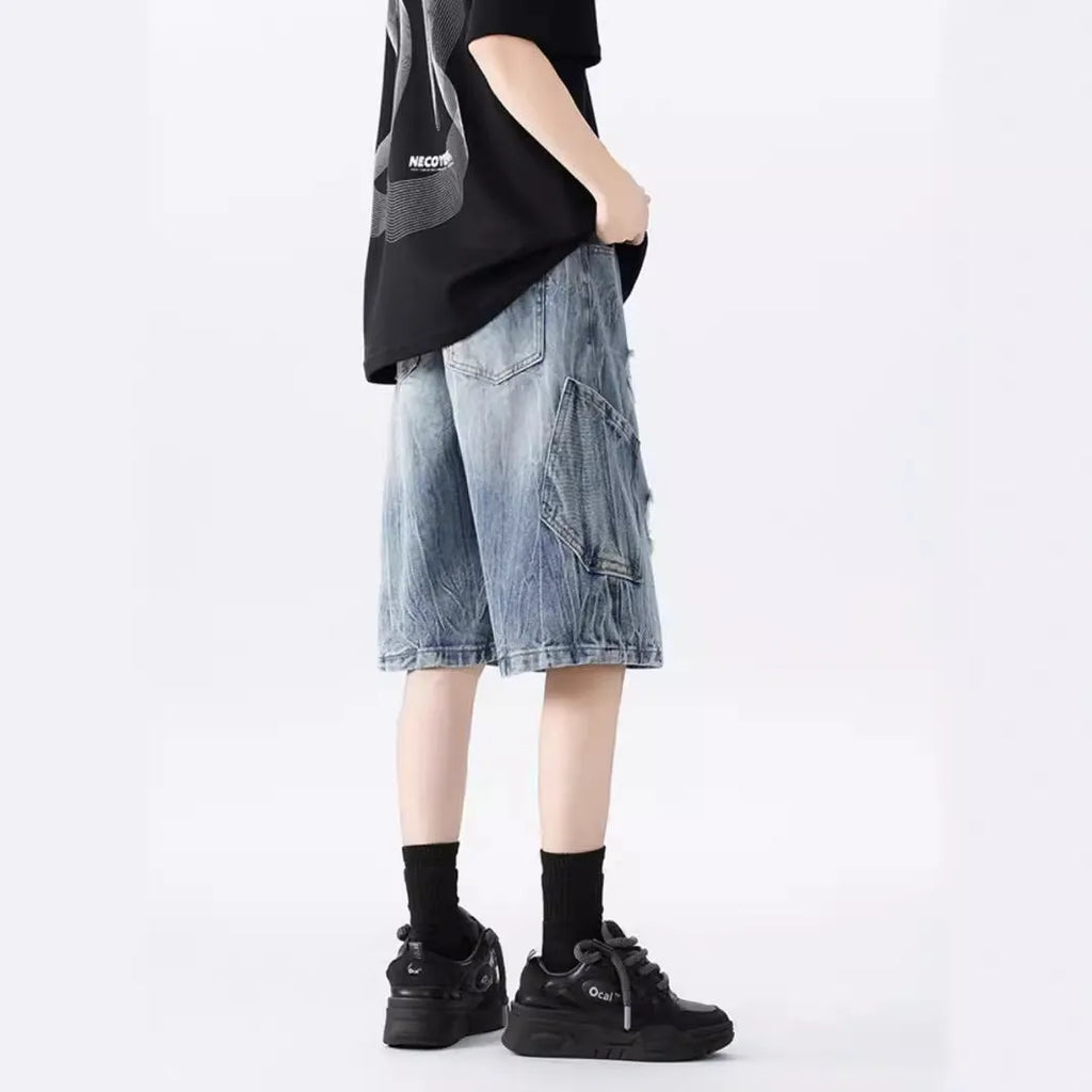 Men's loose-fit washed ripped denim shorts in black and blue colours with distressed detailing and retro styling
