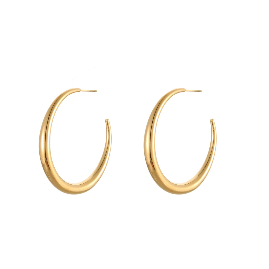 A pair of simple round titanium steel hoop earrings in a gold finish on a white background.