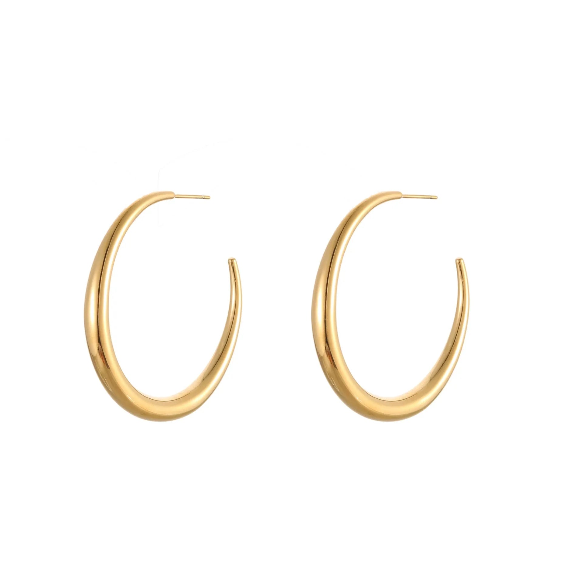 A pair of simple round titanium steel hoop earrings in a gold finish on a white background.