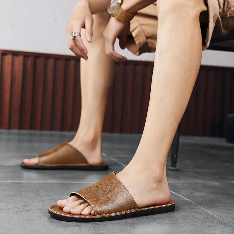 Men's brown leather sandals with adjustable straps and a flat rubber sole on a plain background.
