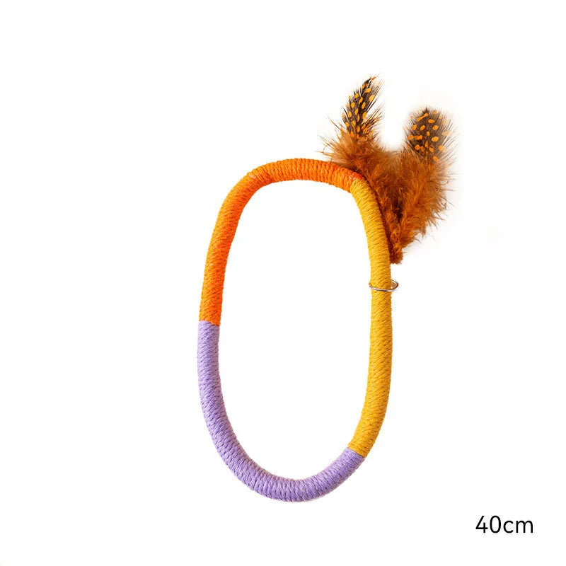Circular cotton rope cat toy with feathers and catnip filling for indoor feline play