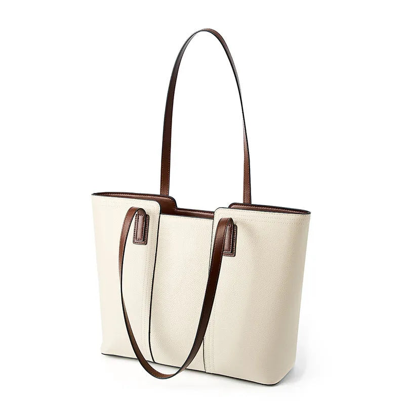 Women's black genuine leather crossbody bag showing internal compartments and horizontal square shape