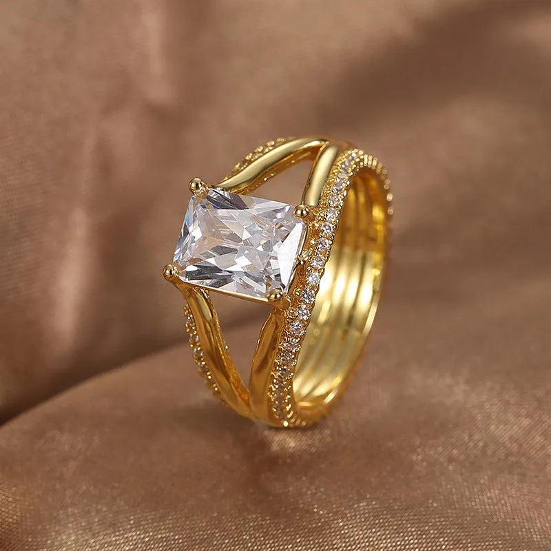 Geometric women's ring with gold electroplated finish and square zircon centrepiece on copper base