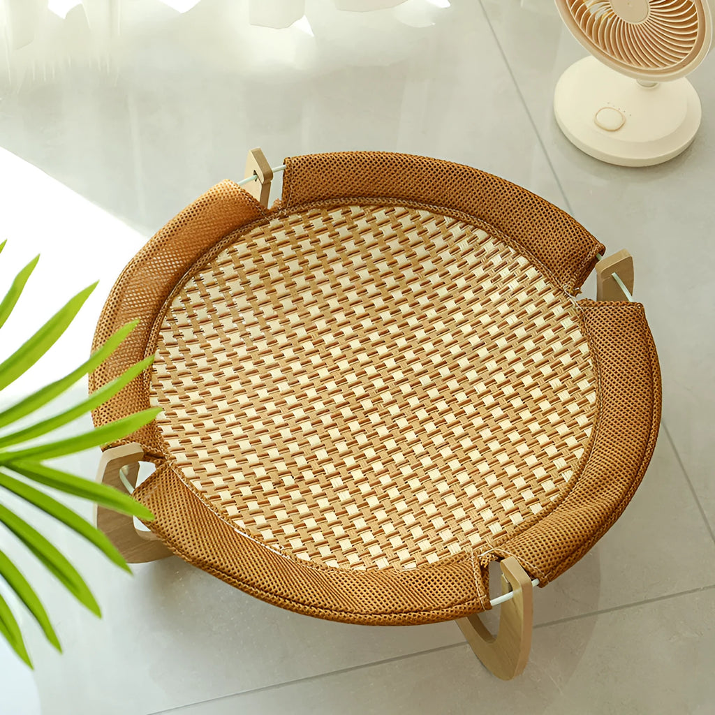 Brown square woven rattan pet hammock bed for cats and small dogs on a wooden floor.