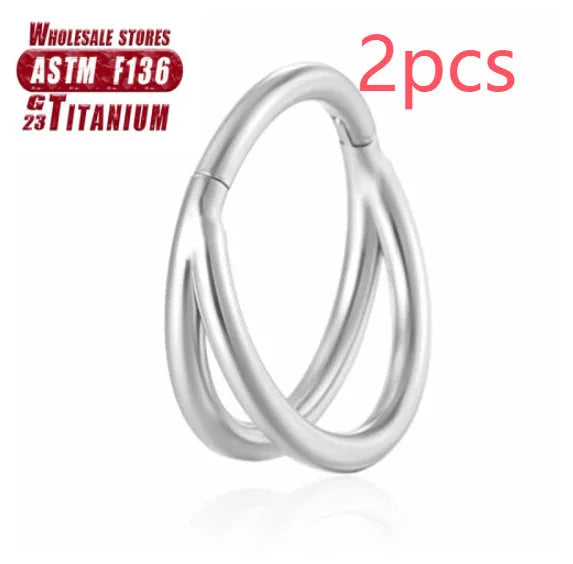 Titanium alloy nose ring on a plain background, shown in silver and gold finishes.